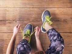 A dancer doing up her Zumba shoes