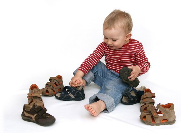 baby putting on shoes by himself