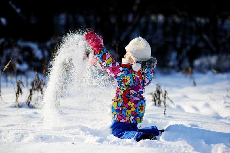 toddler-girl-colorful-snowsuit-plays-snow